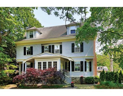 a front view of a house with plants and trees