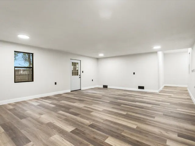 a view of a room with a bed and a window