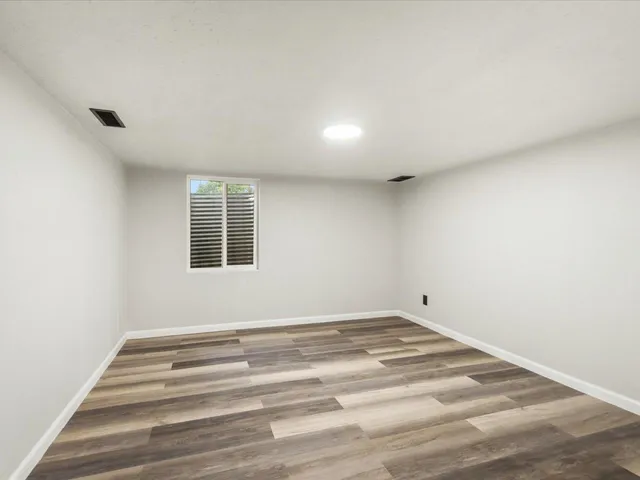 a bathroom with a sink a toilet a mirror and shower