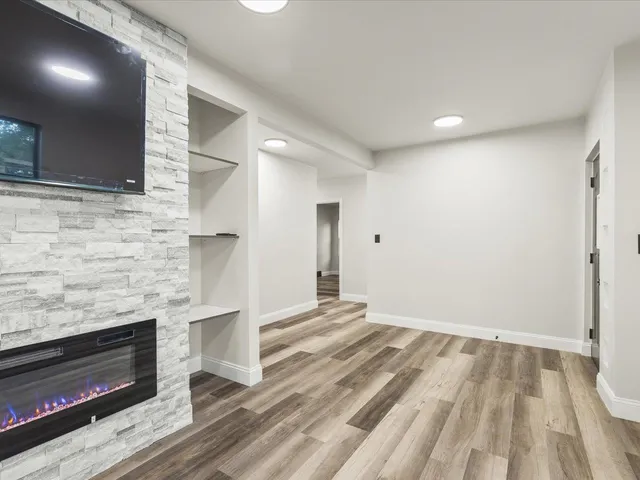 a view of an empty room and wooden floor