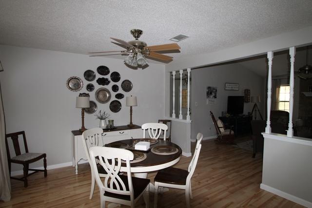 223 Ridge Lake Road Crestview, FL 32536 - Photo 13 of 40 a view of a dining room with furniture and wooden floor