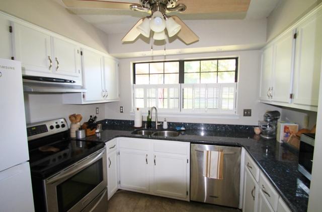 223 Ridge Lake Road Crestview, FL 32536 - Photo 18 of 40 a kitchen with stainless steel appliances a sink a stove a microwave and cabinets