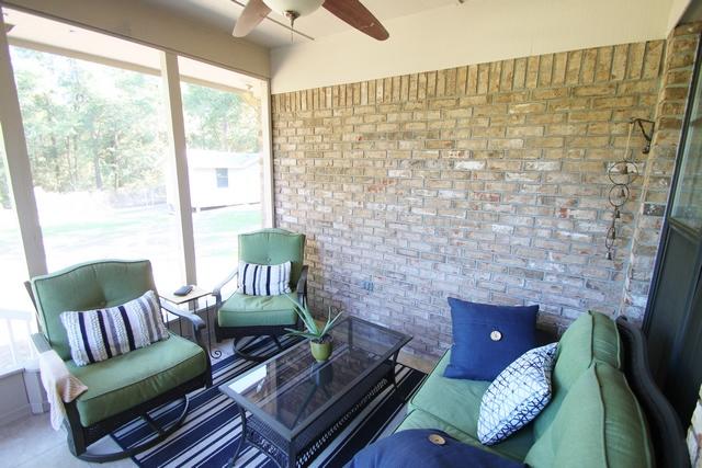 223 Ridge Lake Road Crestview, FL 32536 - Photo 20 of 40 a living room with furniture and a floor to ceiling window