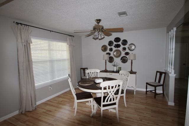 223 Ridge Lake Road Crestview, FL 32536 - Photo 3 of 40 a dining room with chandelier and wooden floor