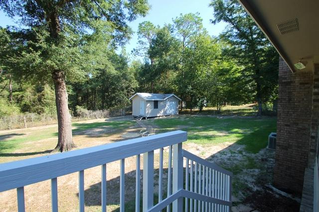 223 Ridge Lake Road Crestview, FL 32536 - Photo 23 of 40 a view of a wooden deck and a backyard