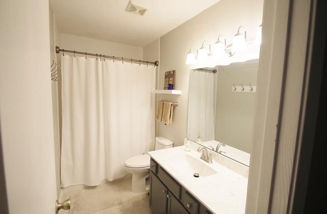 223 Ridge Lake Road Crestview, FL 32536 - Photo 27 of 40 a bathroom with a sink a toilet and shower curtain