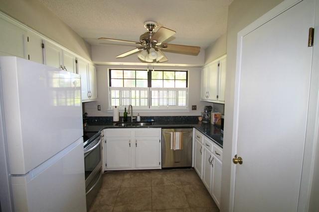 223 Ridge Lake Road Crestview, FL 32536 - Photo 4 of 40 a kitchen with stainless steel appliances a sink a stove a refrigerator a window