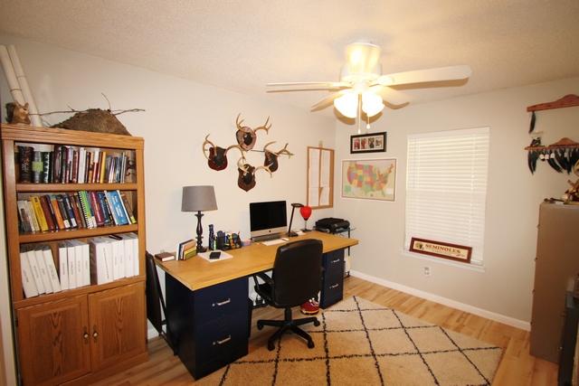 223 Ridge Lake Road Crestview, FL 32536 - Photo 31 of 40 a view of a workspace with furniture and a book shelf