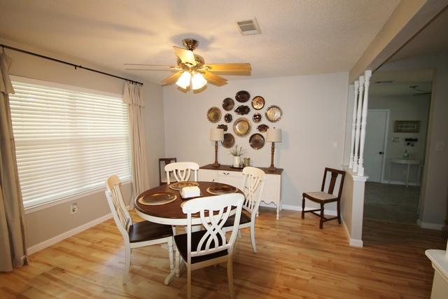 223 Ridge Lake Road Crestview, FL 32536 - Photo 34 of 40 a view of a dining room with furniture and wooden floor