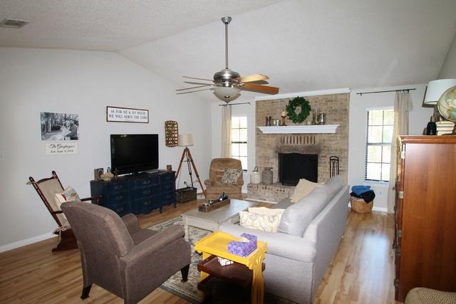 223 Ridge Lake Road Crestview, FL 32536 - Photo 5 of 40 a living room with furniture a fireplace and a flat screen tv