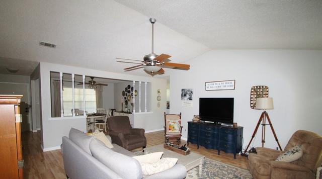 223 Ridge Lake Road Crestview, FL 32536 - Photo 10 of 40 a living room with furniture a flat screen tv and a window