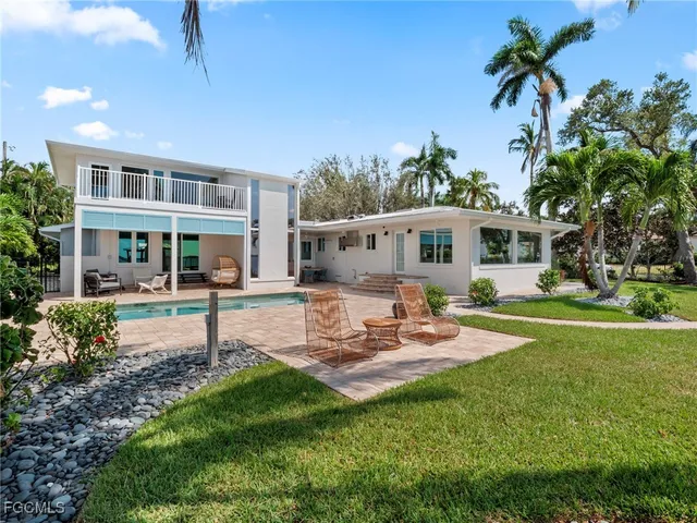 a house view with swimming pool and garden