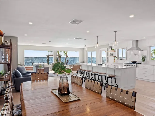 a living room with lots of furniture and hard wood flooring