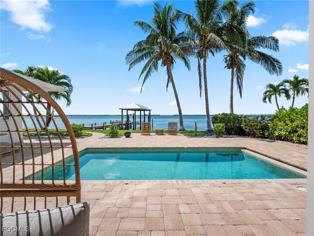 a view of swimming pool with a table and chairs
