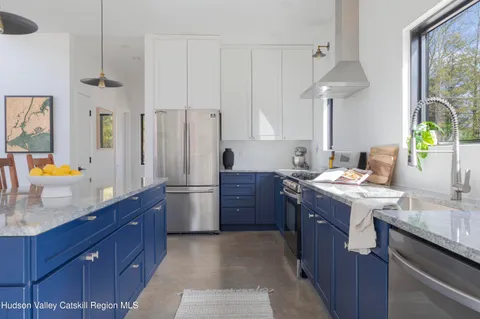 a kitchen with a sink stove and refrigerator