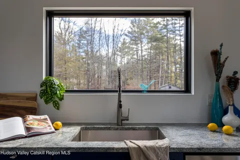 a view of a living room with a sink and a window