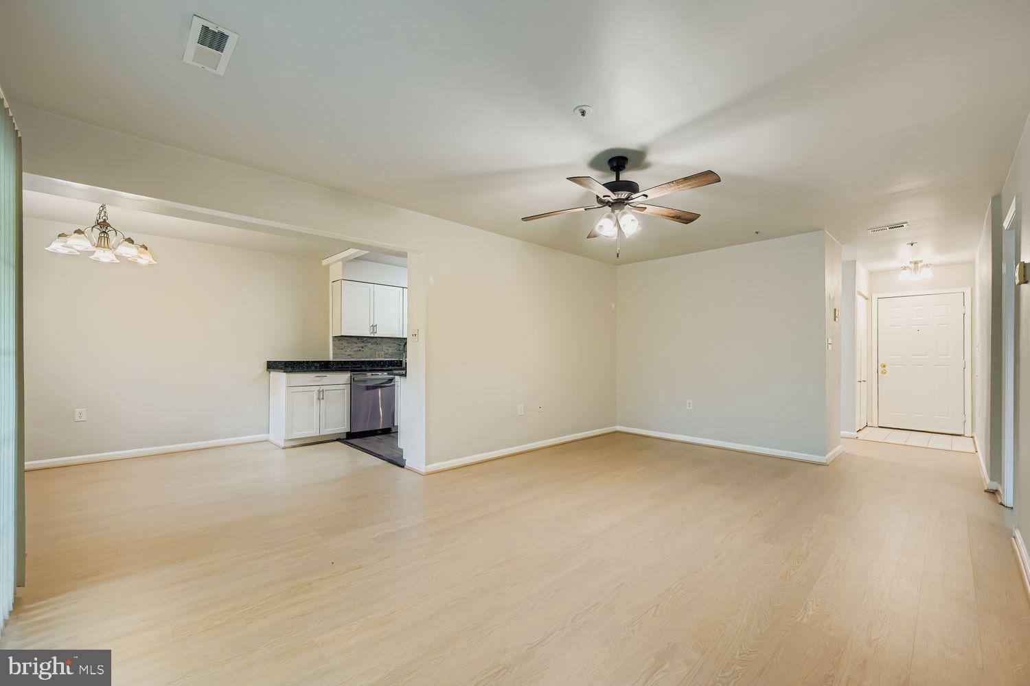 8385 Montgomery Run Road, Unit C Ellicott City, MD 21043 - Photo 3 of 11 wooden floor in an empty room with a chandelier fan
