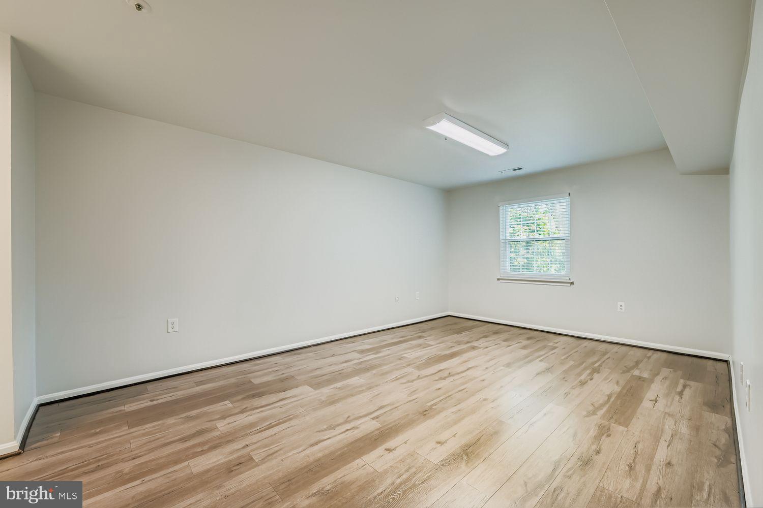 8385 Montgomery Run Road, Unit C Ellicott City, MD 21043 - Photo 9 of 11 an empty room with wooden floor and windows