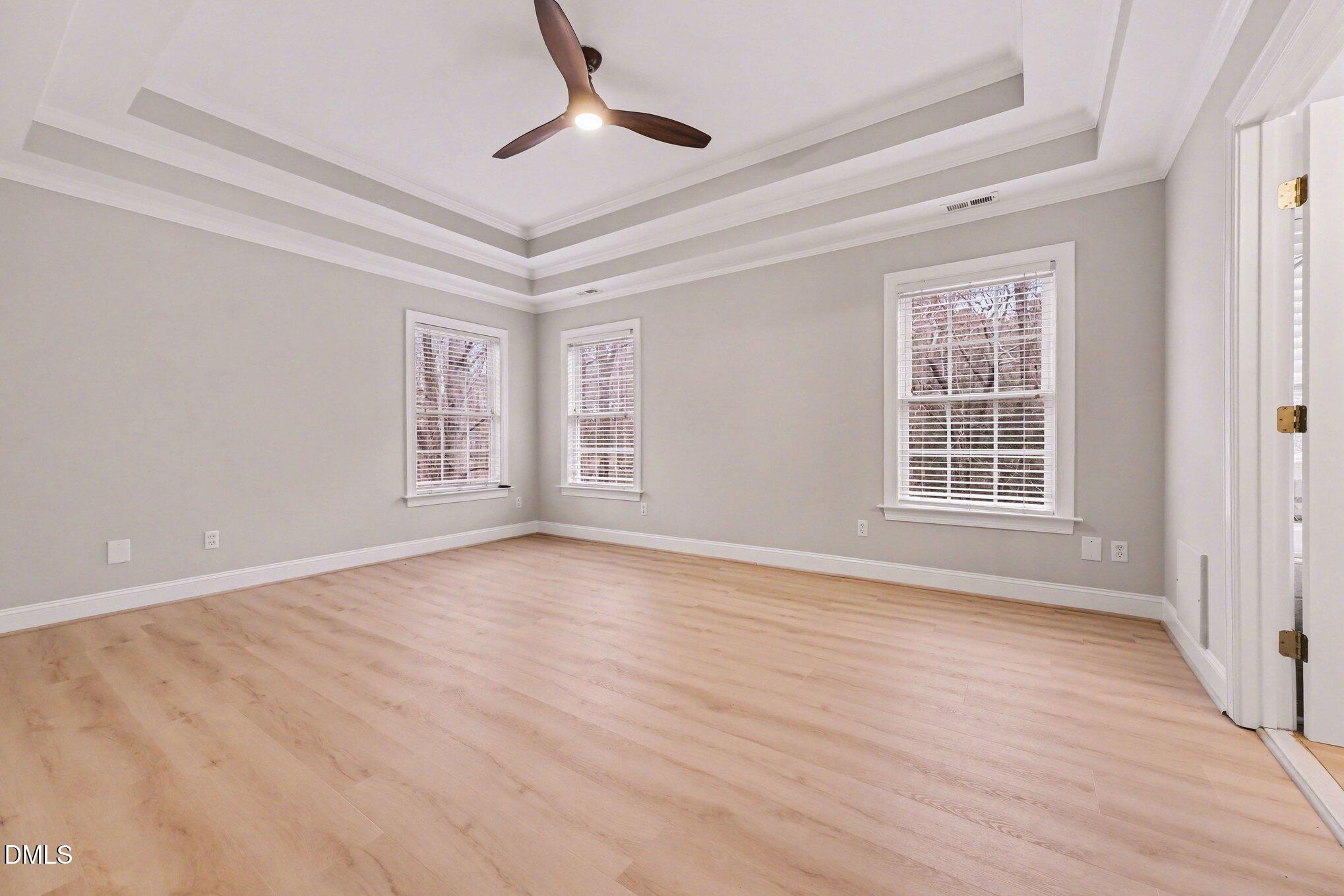 4613 Cherrybark Lane Raleigh, NC 27616 - Photo 17 of 27 a view of an empty room with wooden floor and a window