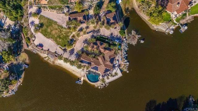 a kitchen with stainless steel appliances kitchen island granite countertop a table chairs sink and cabinets