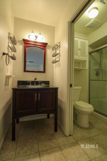 1043 Peg Street Ridgecrest, CA 93555 - Photo 30 of 45 a bathroom with a toilet sink and mirror