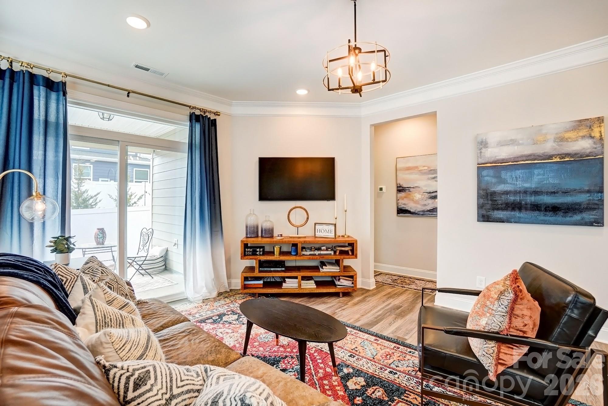 3925 Rothwood Lane Harrisburg, NC 28075 - Photo 14 of 48 a living room with furniture and a flat screen tv