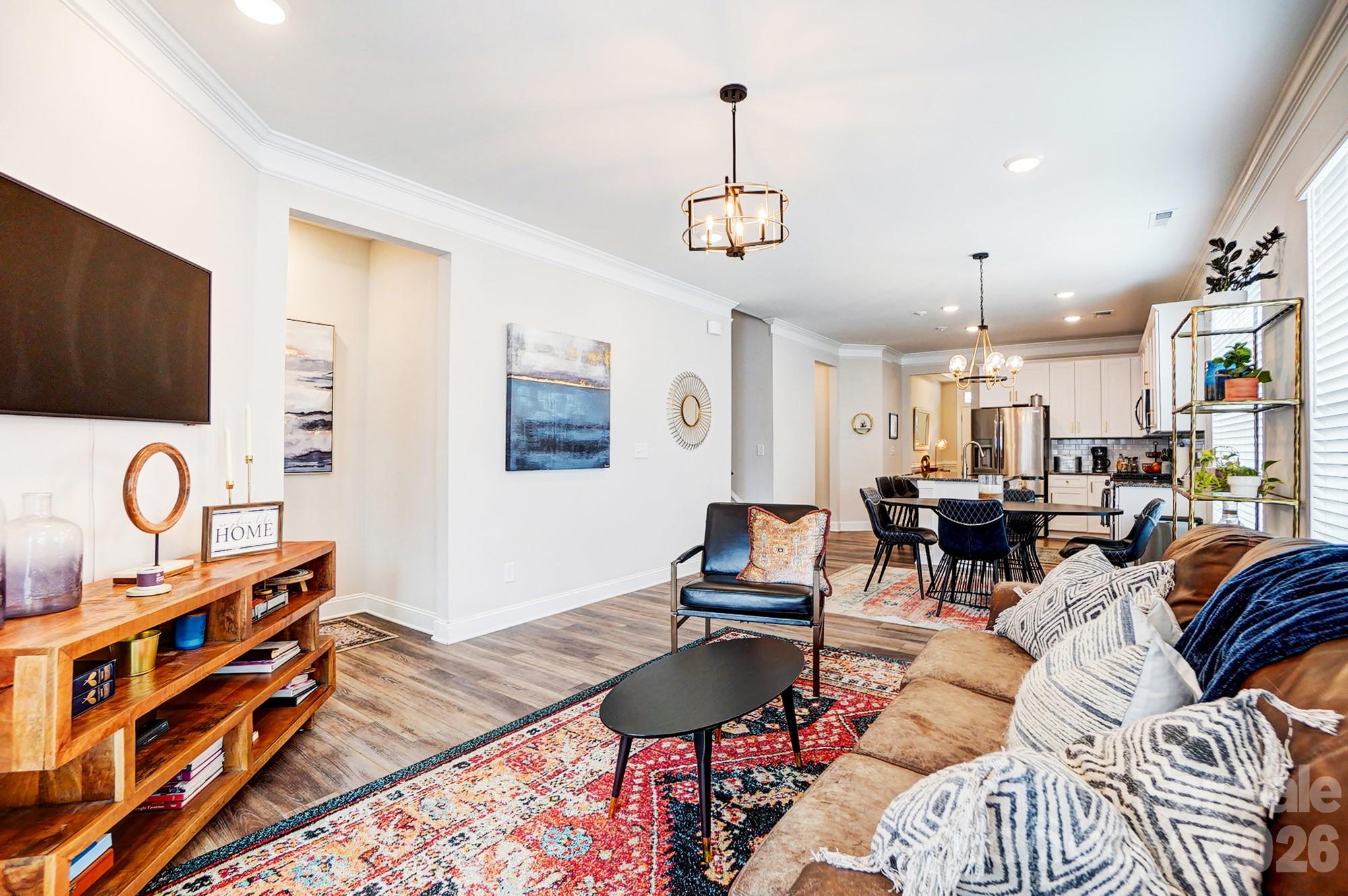 3925 Rothwood Lane Harrisburg, NC 28075 - Photo 16 of 48 a living room with furniture a rug and a flat screen tv