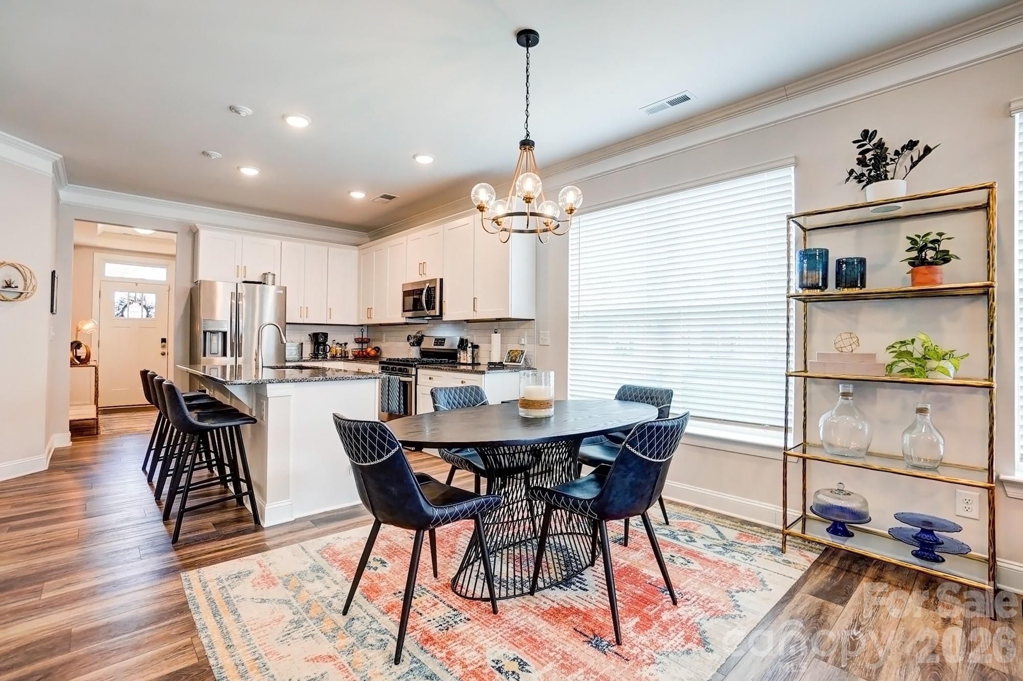 3925 Rothwood Lane Harrisburg, NC 28075 - Photo 17 of 48 a view of a dining room with furniture and wooden floor