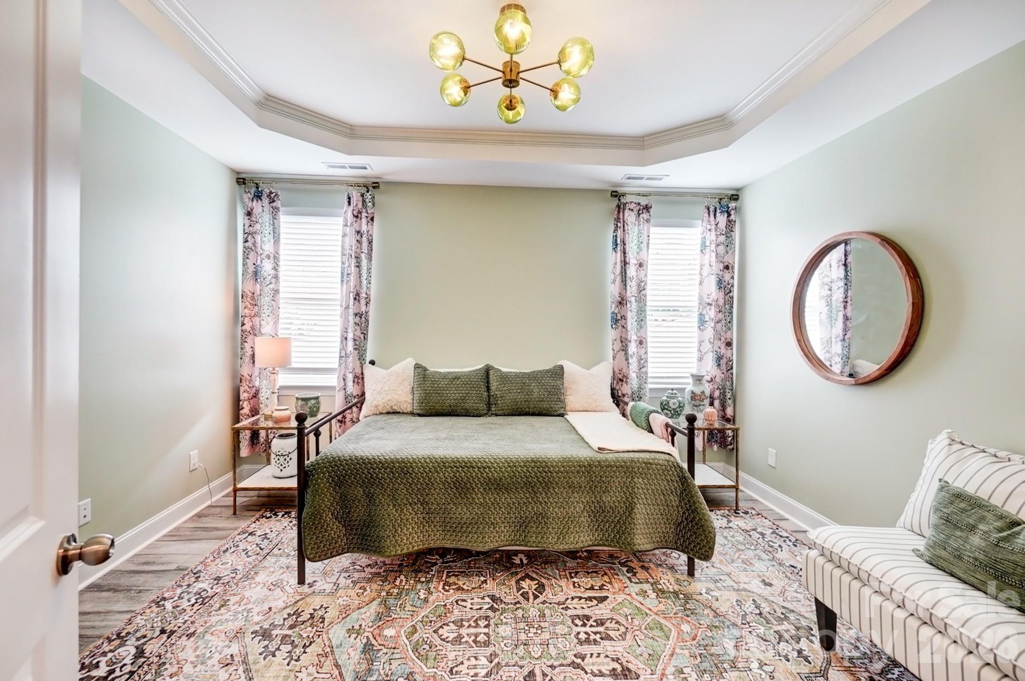 3925 Rothwood Lane Harrisburg, NC 28075 - Photo 21 of 48 a bedroom with a bed a mirror and a window