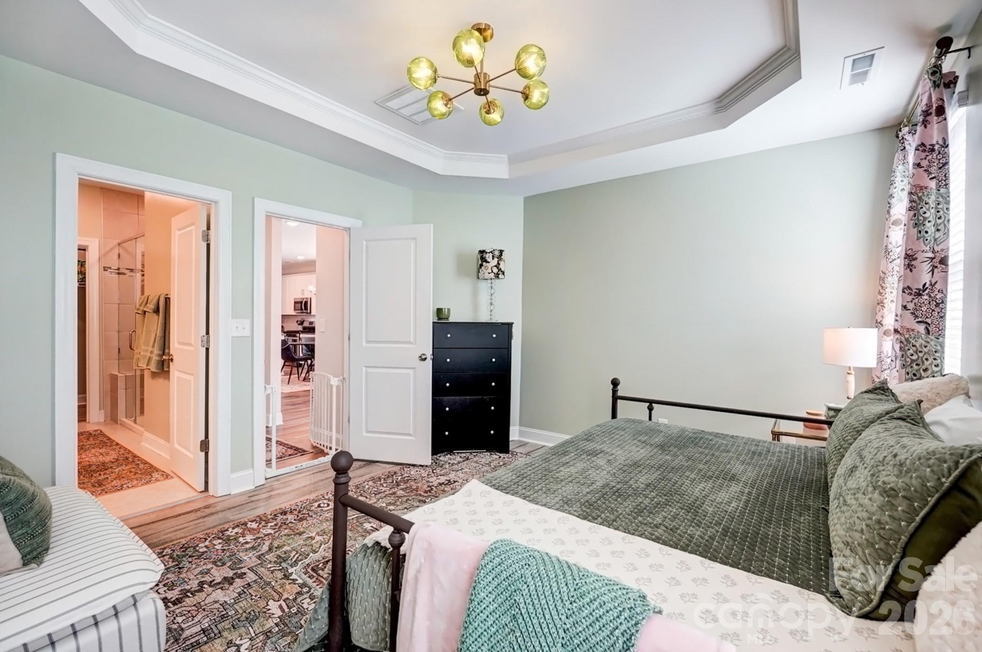 3925 Rothwood Lane Harrisburg, NC 28075 - Photo 23 of 48 a bedroom with a bed and a chandelier