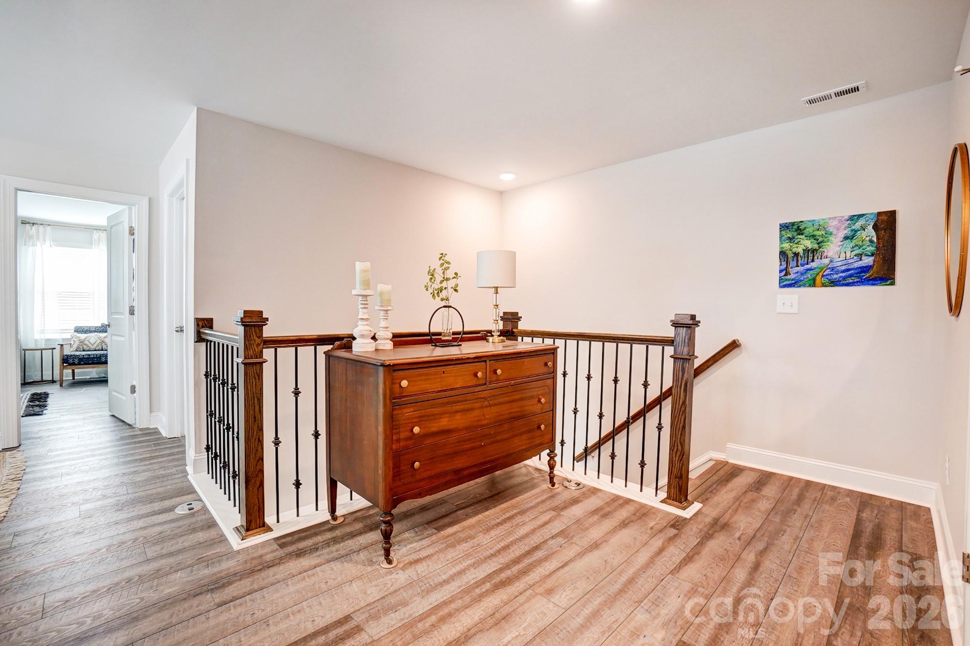 3925 Rothwood Lane Harrisburg, NC 28075 - Photo 28 of 48 a view of a hallway with wooden floor and stairs