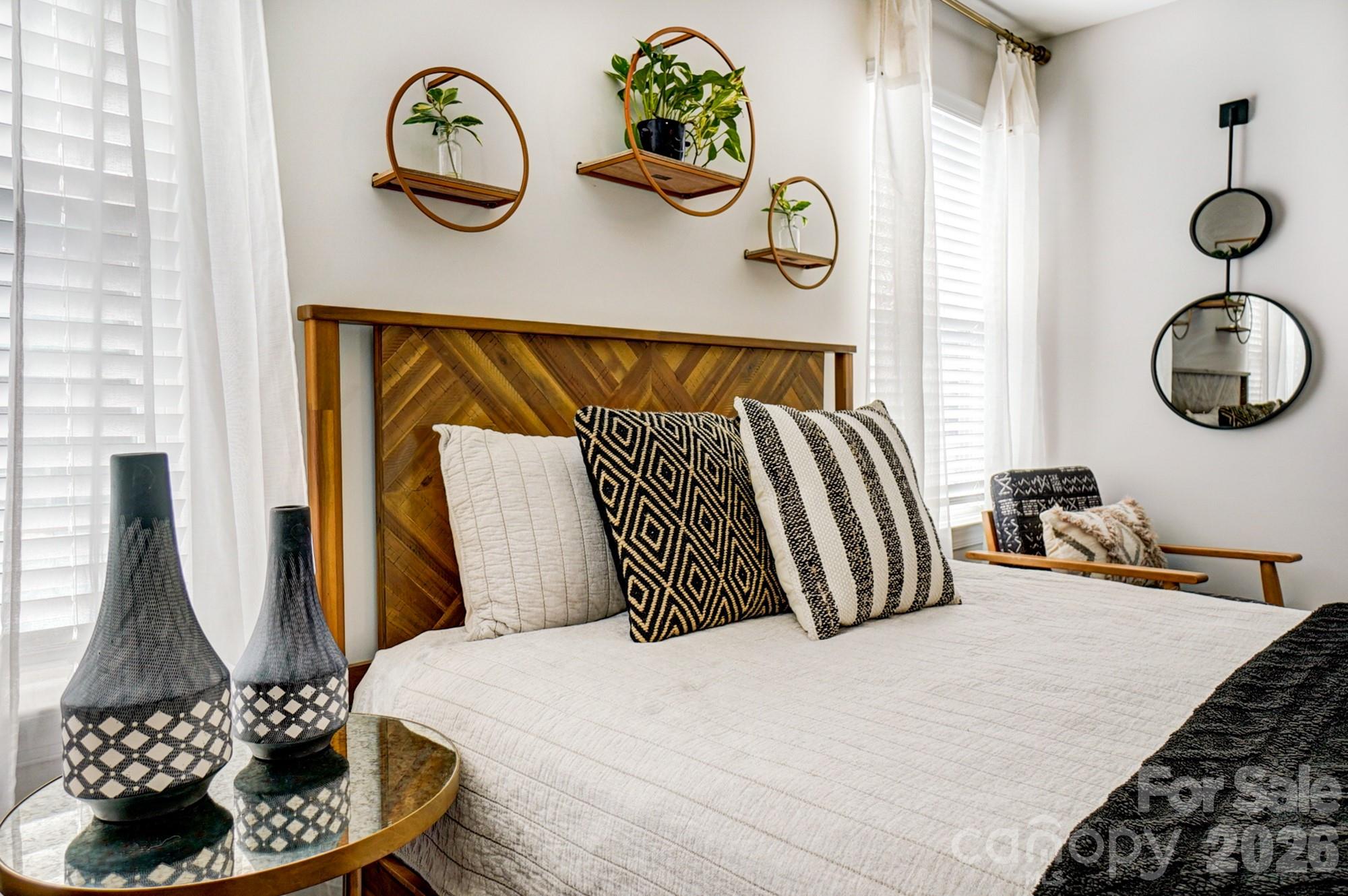 3925 Rothwood Lane Harrisburg, NC 28075 - Photo 43 of 48 a bedroom with a bed and a chandelier