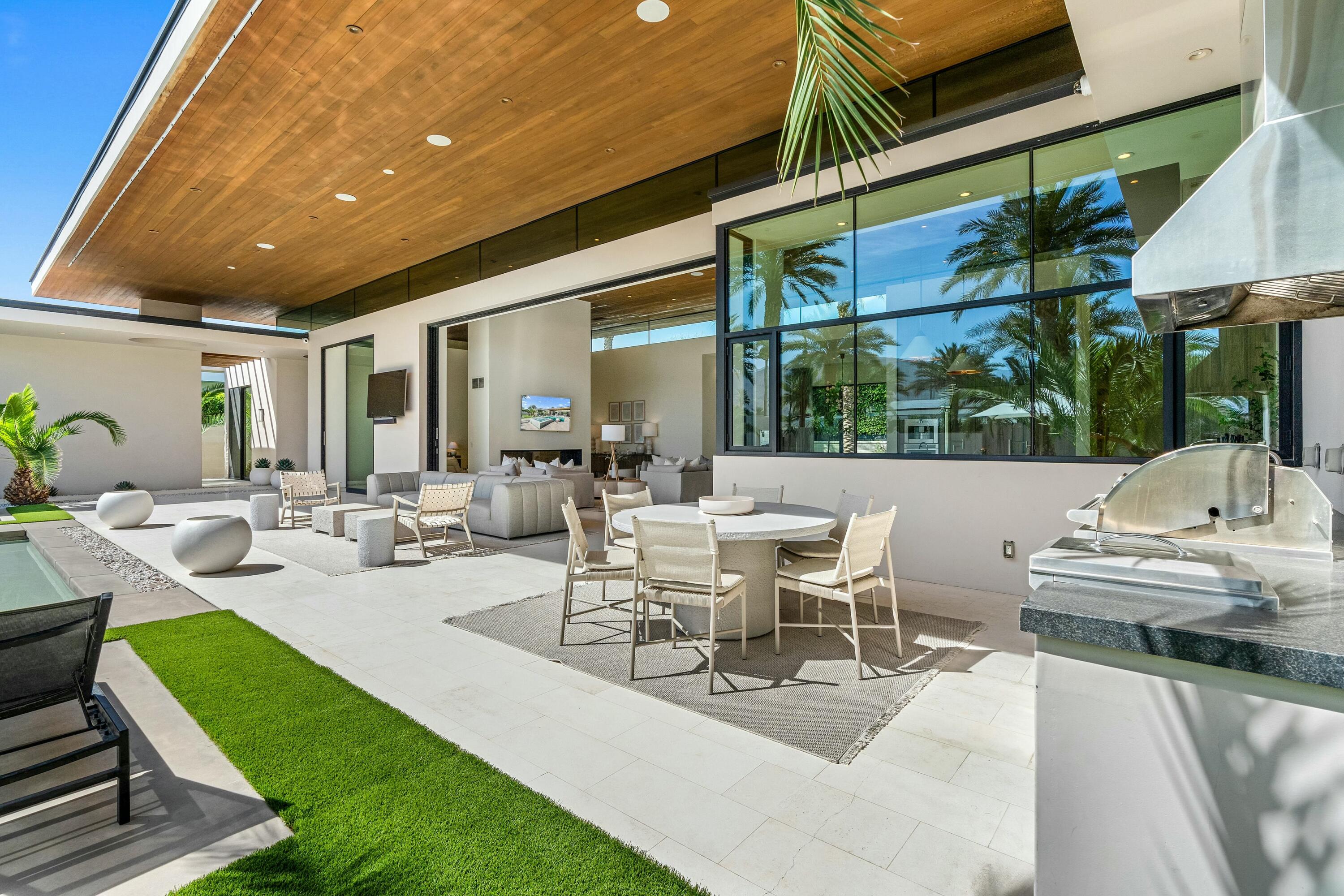 3 Makena Lane Rancho Mirage, CA 92270 - Photo 19 of 38 a view of a patio with couches table and chairs and potted plants