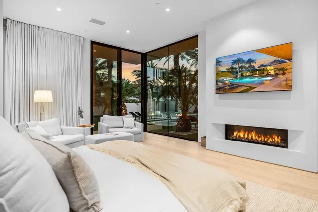 a bedroom with a bed and a large window