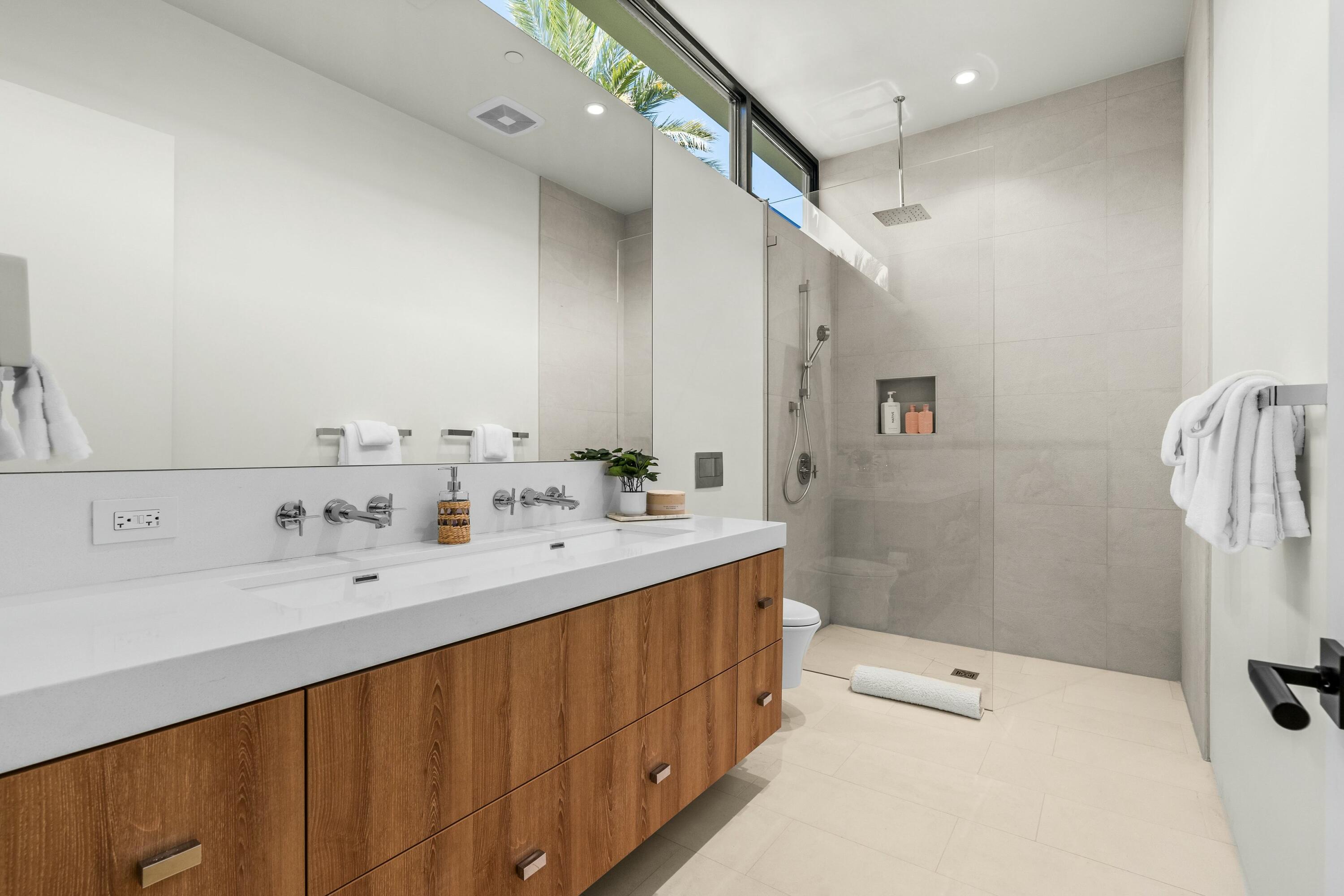 3 Makena Lane Rancho Mirage, CA 92270 - Photo 28 of 38 a spacious bathroom with a double vanity sink a mirror and a bathtub