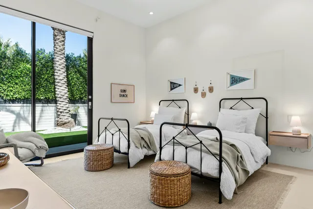 a bedroom with furniture and a large window