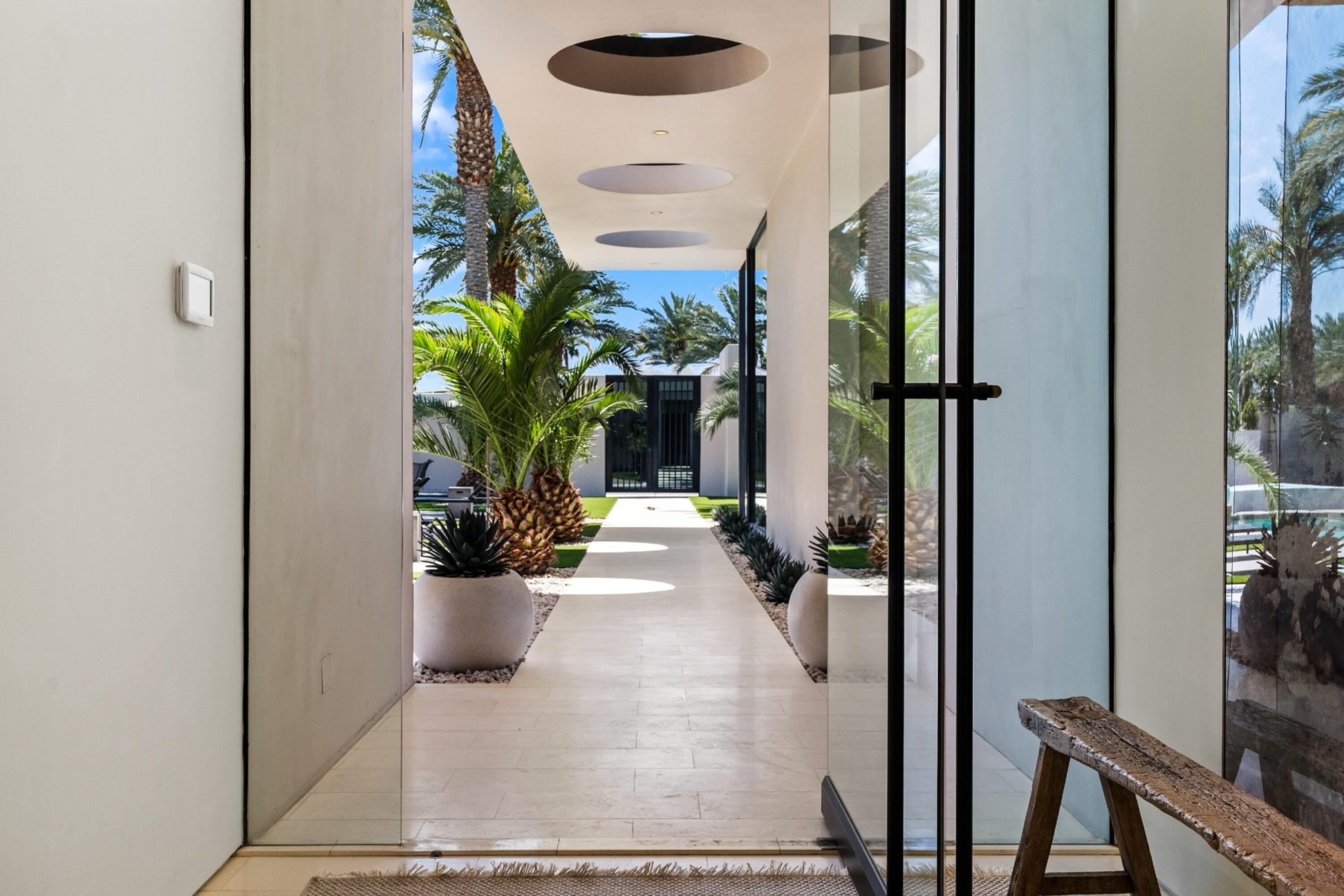 3 Makena Lane Rancho Mirage, CA 92270 - Photo 3 of 38 a view of a hallway with wooden floor and a potted plant