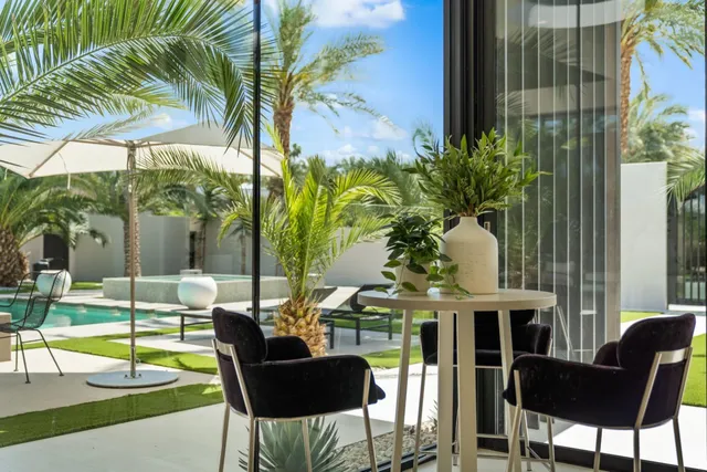 a view of a patio with table and chairs and potted plants