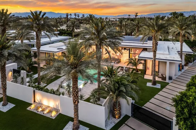 a view of a house with a yard from a balcony
