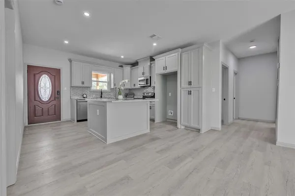 a kitchen with stainless steel appliances granite countertop a refrigerator and a stove top oven
