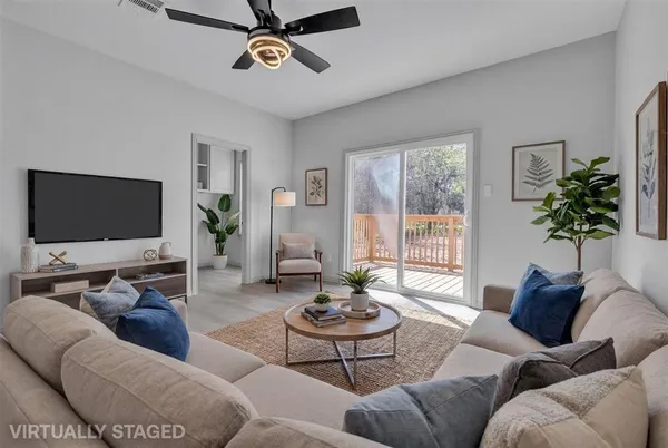 a living room with furniture and a flat screen tv