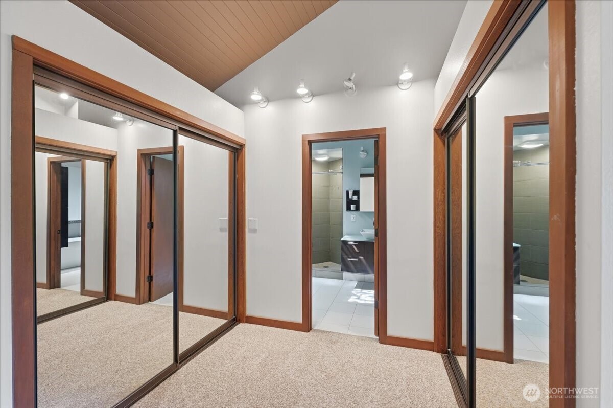 9418 Odin Way Bothell, WA 98011 - Photo 21 of 39 a view of a hallway with bathroom and glass door