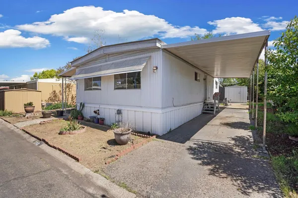 a view of a backyard with sitting area