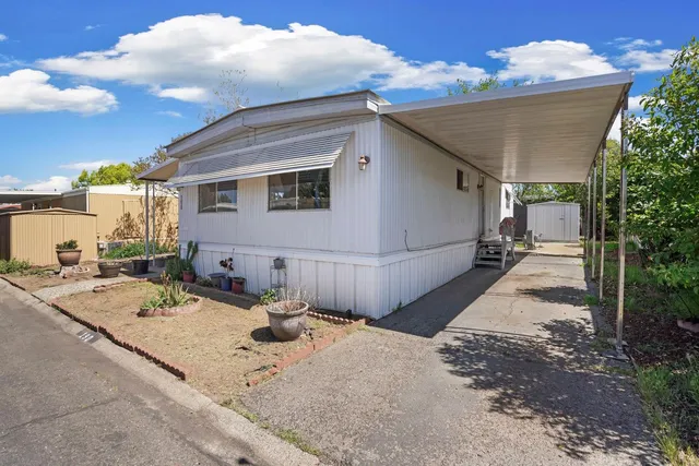 a view of a backyard with sitting area