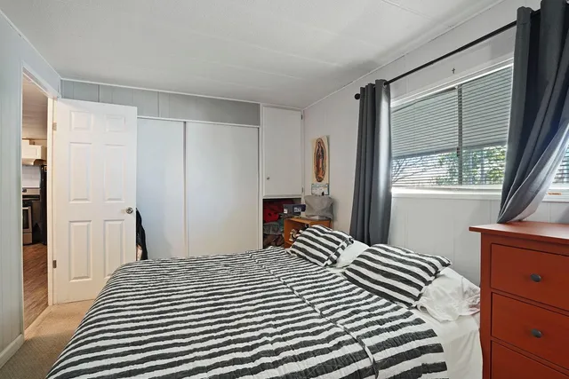 a bedroom with a large bed and a window