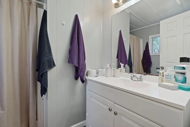 a bathroom with a sink vanity and a mirror