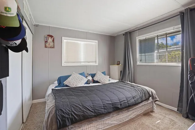 a bedroom with a bed and glass window