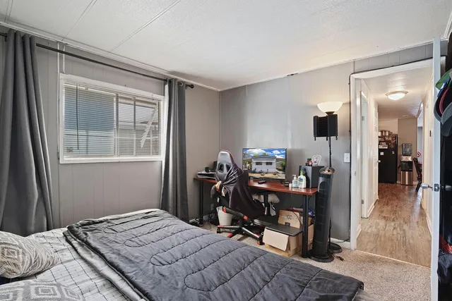 a bedroom with a bed and a window