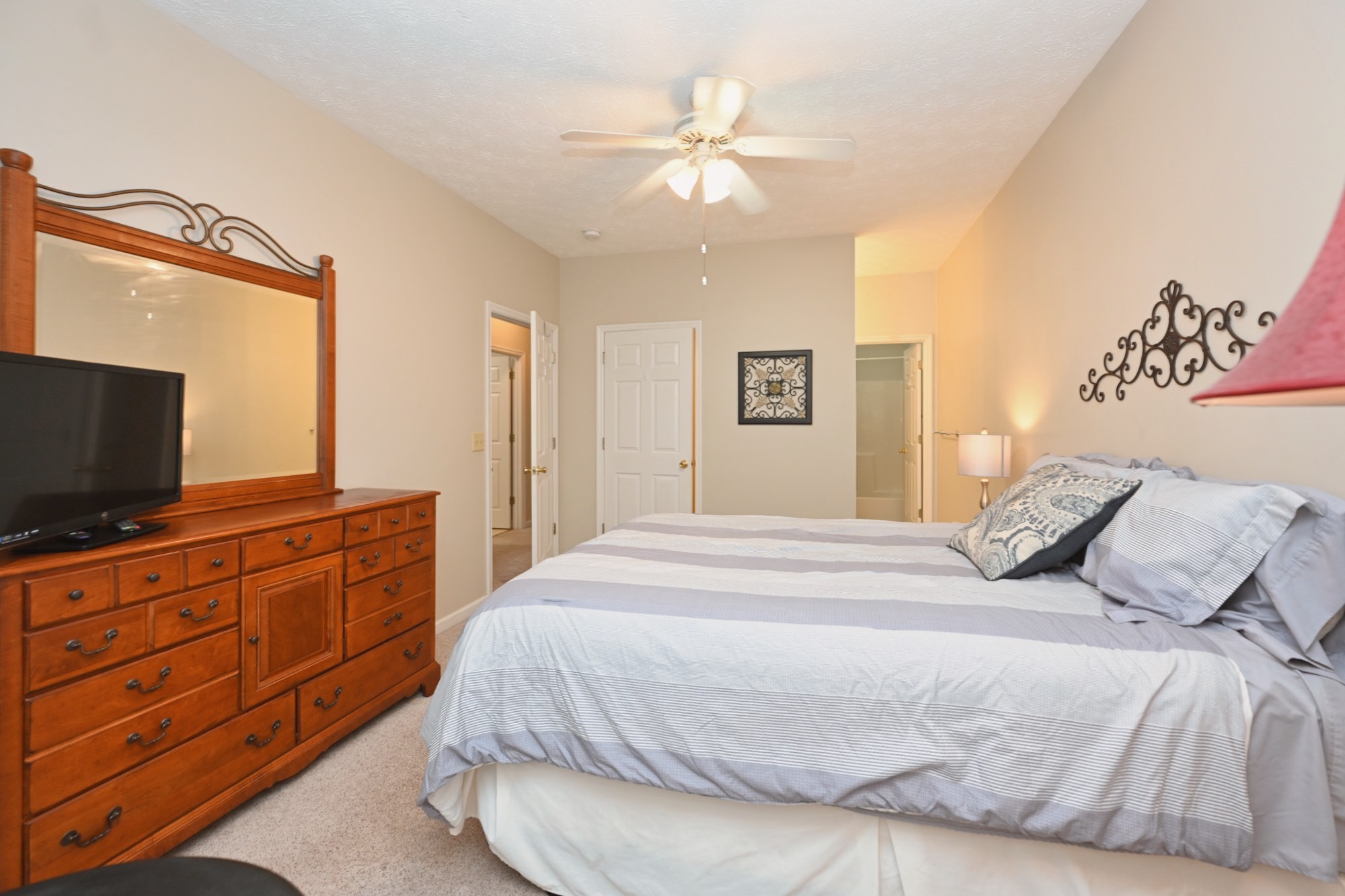 910 Churchill Crossing Madison, TN 37115 - Photo 17 of 38 a bedroom with a large bed and a flat screen tv