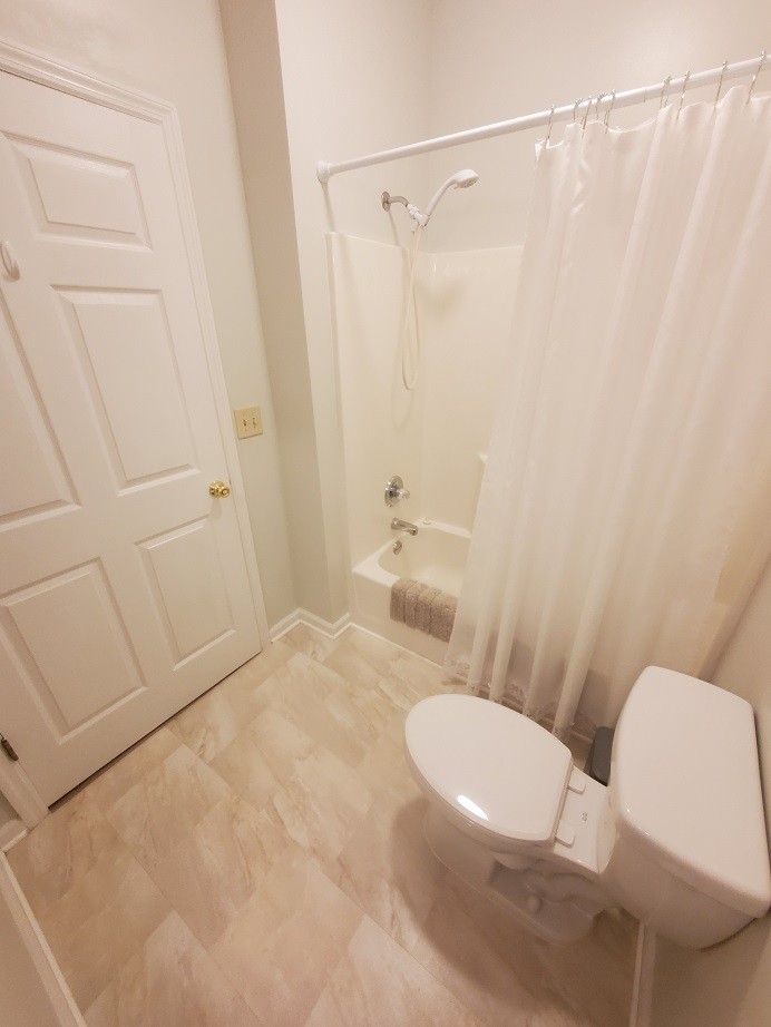 910 Churchill Crossing Madison, TN 37115 - Photo 27 of 38 a white toilet sitting next to a bathroom sink